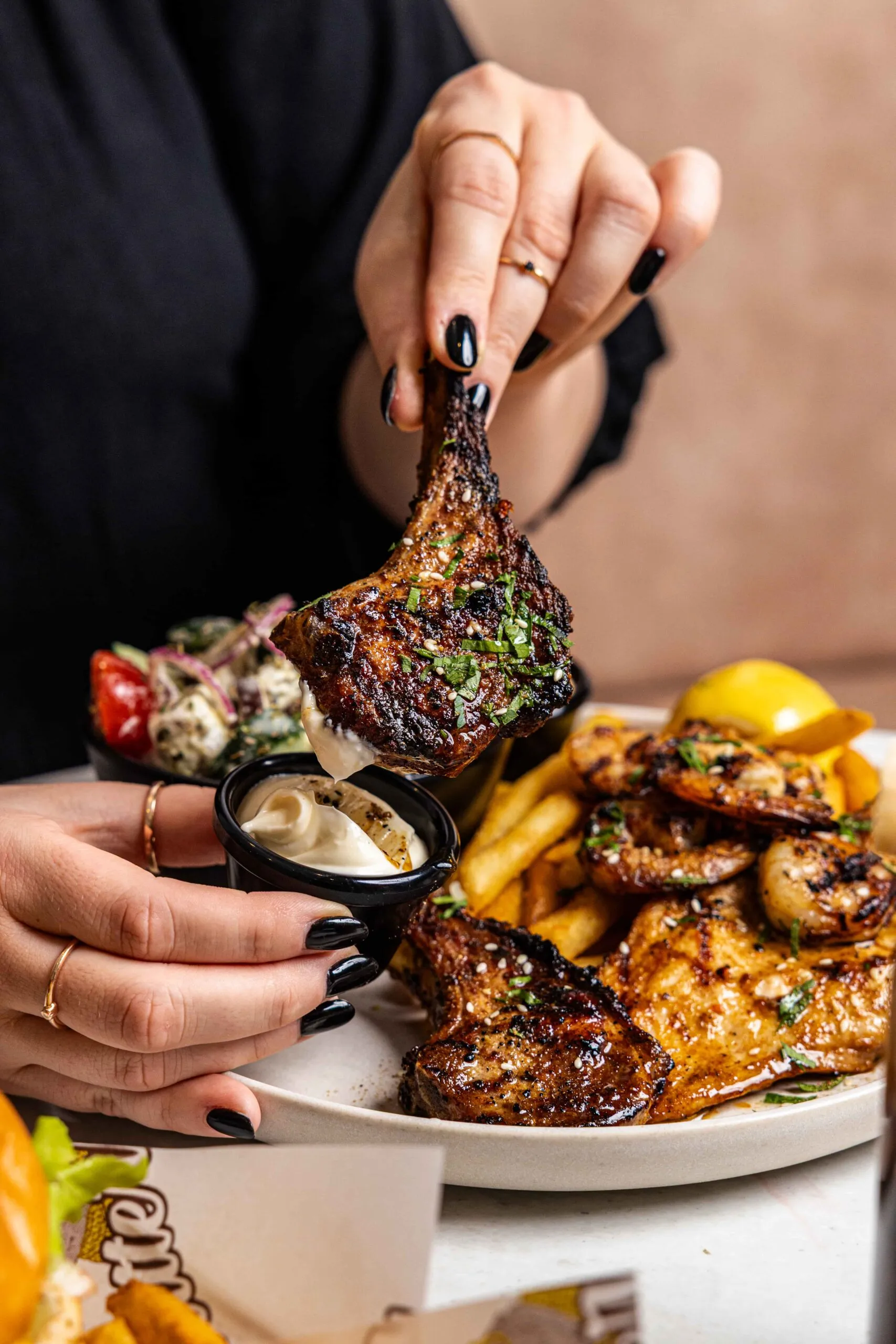 A mixed grill plate of lamb cutlets, chicken, prawns, chips and salad with aioli