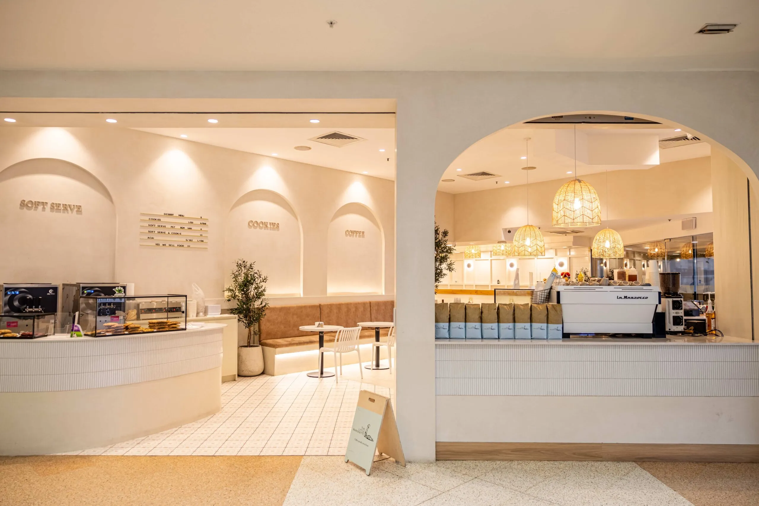 Inside Butter Bear Café — arched white joinery, the soft-serve counter and La Marzocco espresso station